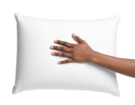 A hand rests gently on a soft, white pillow, emphasizing its plush texture and comfort.