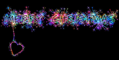 Kolorowe zimne ognie i fajerwerki układające się w kształt świątecznych życzeń: Merry Christmas w języku angielskim.