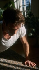 Sun-kissed shadows frame a Caucasian man's serene morning yoga, embodying mindfulness during International Day of Peace and World Yoga Day