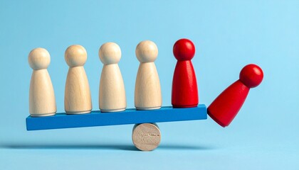 Obraz premium wooden figurines on seesaw showing imbalance with one red figure falling off