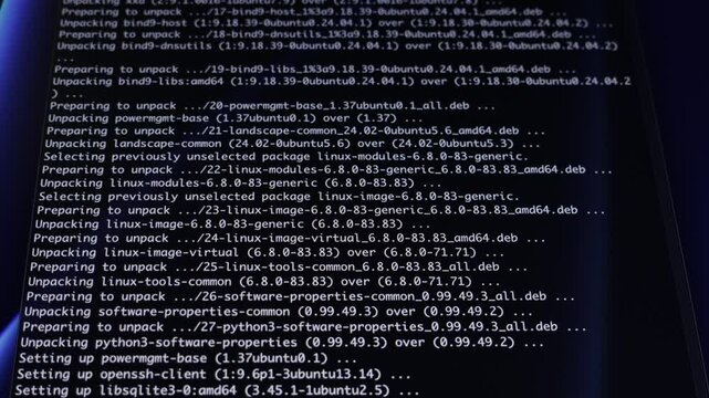 Programming code scrolling on a dark computer screen displays software installation, illustrating ongoing digital development, technical work, and system administration