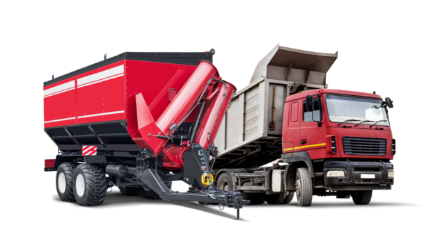 A red agricultural trailer is connected to a truck, both isolated on a white background.
