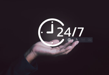 Hand holding digital 24 clock icon representing nonstop service, online support, and customer care. Concept of business availability, communication technology, and continuous connection in operations.