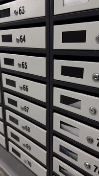 Mailboxes in the front door.
Numbered mailboxes in the house.
Address mail delivery.
Box, mailbox, mail, cell