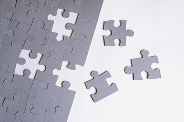 Obraz premium Jigsaw puzzle with missing pieces on white background. Concept of solving problem. Copy space