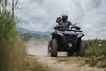 People riding an all-terrain vehicle on a trail surrounded by lush greenery and open skies. The scene evokes a sense of adventure and outdoor exploration, highlighting the thrill of the journey. © qunica.com