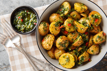 roasted chimichurri potatoes are a great side dish all year round closeup on the plate on the table. Horizontal top view from above