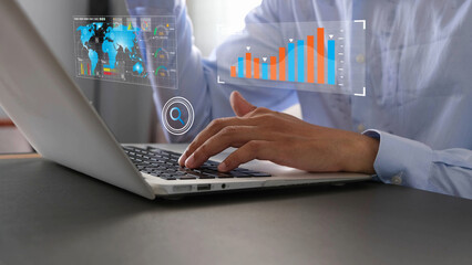 Businessman analyzing data on laptop with futuristic digital graphs and charts, showing global analytics, financial growth, and technology innovation in modern office setting