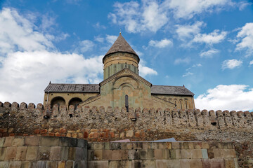 Fototapeta premium The outside view of Svetitskhoveli Cathedral which is an Orthodox Christian cathedral located in the historic town of Mtskheta, Georgia, The cathedral is surrounded by a stone wall