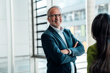 Business teamwork in office with senior and mid adult complementing each other