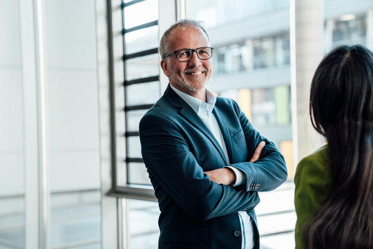 Business teamwork in office with senior and mid adult complementing each other