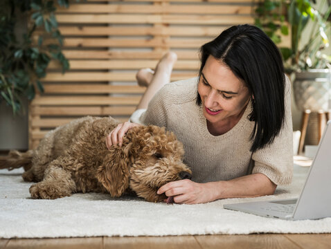 Woman lying near dog at home