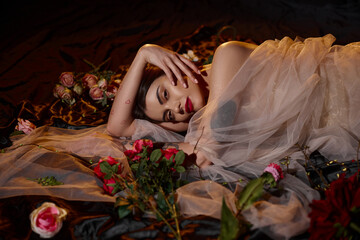 Dreamy fashion scene with a young woman in chiffon among a sea of flowers