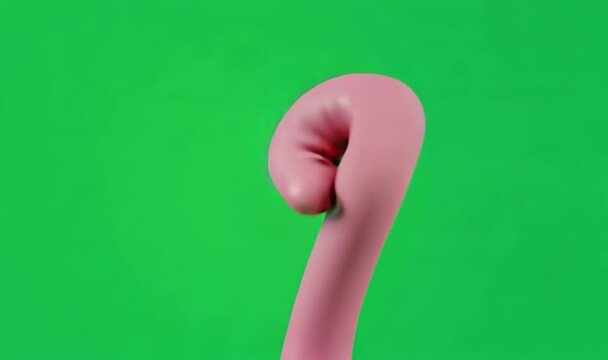 Close up of a pink candy cane hook against a green background.