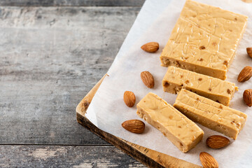 Christmas soft almond nougat bar on wooden table. Copy space
