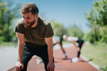 Man catching his breath after outdoor activity, with focus on effort and determination.