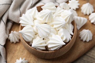 Delicious meringue cookies on wooden table, closeup