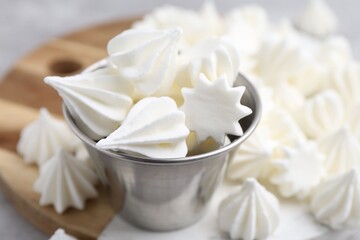 Delicious meringue cookies on table, closeup view