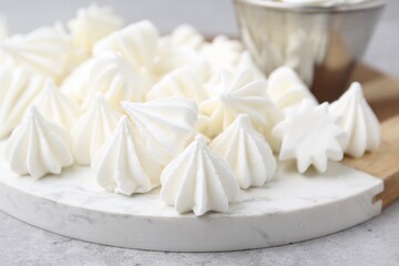 Delicious meringue cookies on grey table, closeup