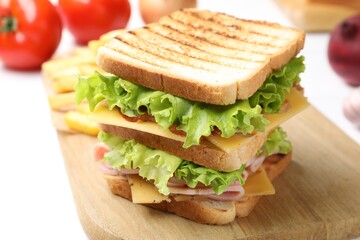 Tasty sandwich served with french fries on white table, closeup