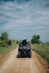 Fototapeta premium A group of riders embarks on an exciting quad bike journey through scenic countryside trails. This off-road adventure showcases the thrill of outdoor exploration and the beauty of rural landscapes.