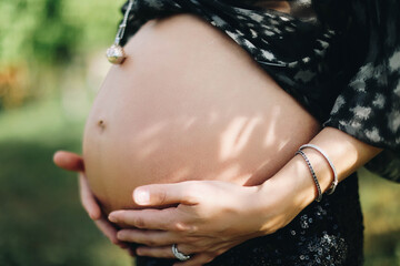 pregnant woman holding her belly