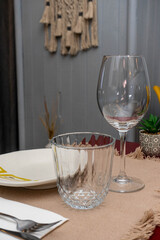 Small restaurant table set for a meal with cutlery, wine glasses, and a cozy atmosphere. Perfect for illustrating dining, hospitality, or local gastronomy concepts.
