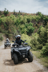 Friends enjoying an outdoor quad bike adventure along a scenic trail surrounded by nature. © qunica.com