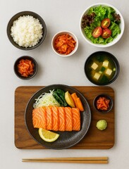 Japanese meal set with salmon sashimi, rice, miso soup, salad, kimchi, and pickles—balanced, fresh, and beautifully arranged