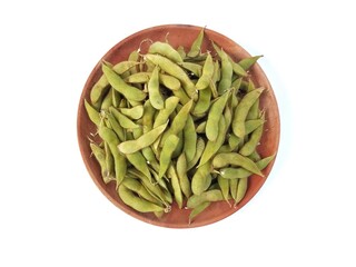 Fresh green soybeans on wooden plate isolated on white background. Flat lay 
