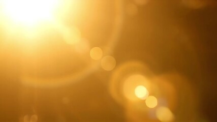 Golden light flares dance across a warm, abstract background - Powered by Adobe