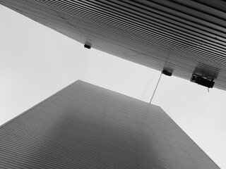 High-rise apartment black and white buildings seen from below, wall, end view of the building against the skyline.