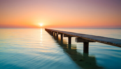 Fototapeta premium Golden sunset over the pier, its silhouette framed by dusk clouds above the calm ocean water