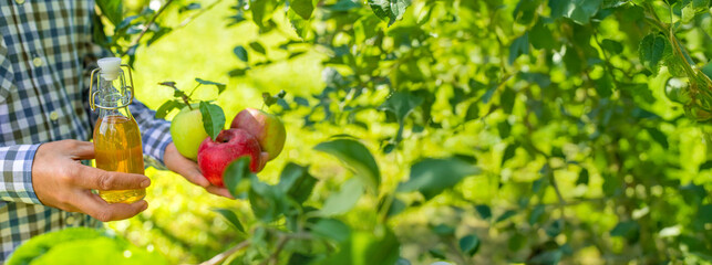 Apple cider vinegar against a background of apples. Selective focus.