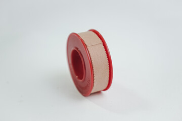 Focus on wound care and protection: a beige medical adhesive tape, partially unrolled, signifying immediate first aid and health support.