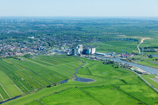 Aerial view of small harbor city surrounded by green fields. Husum, Germany
