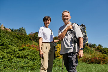 Senior couple enjoys a perfect day of hiking together in nature