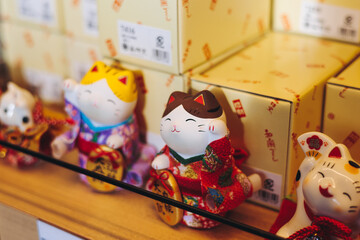 Traditional Japanese tourist souvenirs and gifts from Tokyo, Japan, with mount Fuji figures, fridge magnets, Maneki-neko beckoning cat figurine, key ring keychain, in a local vendor gift shop