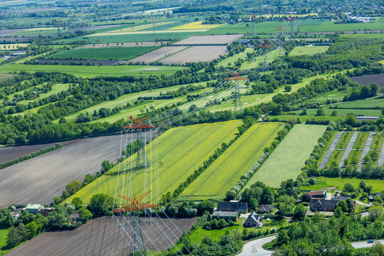 Aerial view of forest, fields, and plowed farmland.