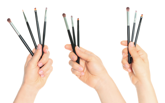 Set of hands holding cosmetic brushes isolated on transparent background