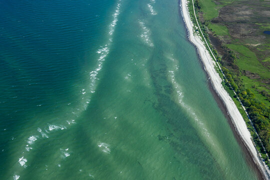 Aerial image of coastline and farm land in rural Denmark.