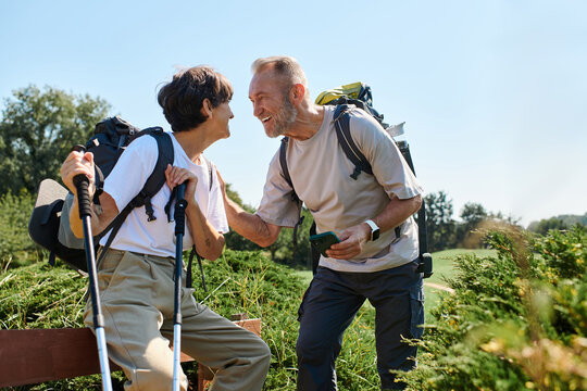Joyful senior couple enjoys an adventurous hike in nature together - Powered by Adobe