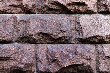 Textured stone wall with rough surfaces and natural colors close-up of architectural materials, stone background close-up