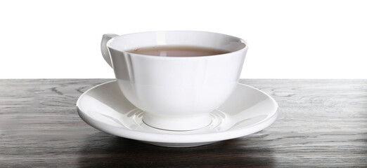 Cup of aromatic black tea on dark wooden table against white background