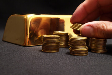  Gold bars with coins on a golden background