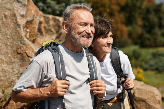 Senior couple enjoys hiking together in stunning mountain scenery - Powered by Adobe