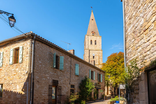 Street and church in the medieval village of Puycelsi, in the Tarn department, Occitanie, France