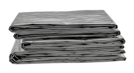Three neatly stacked, folded, crinkled gray sheets of plastic or tarp material