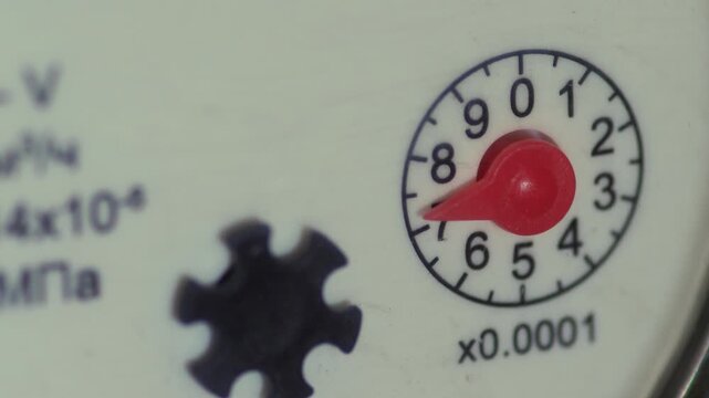 Water meter with a rotating arrow, close-up of a water meter, verification of metering devices