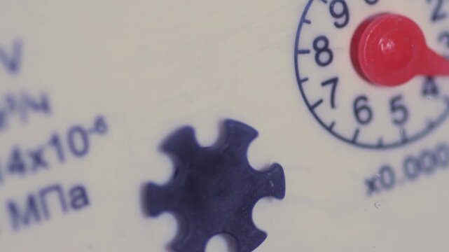 Energy metering, water concept, macro rotating arrow of a water or gas meter, energy metering